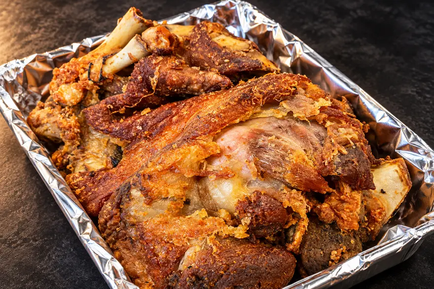 Crispy Pata in a foil-lined tray